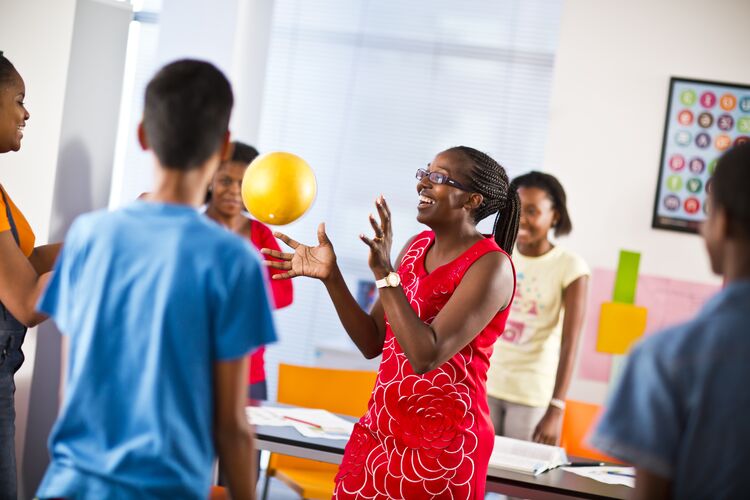 British Council teacher in Mozambique throwing a ball to a student