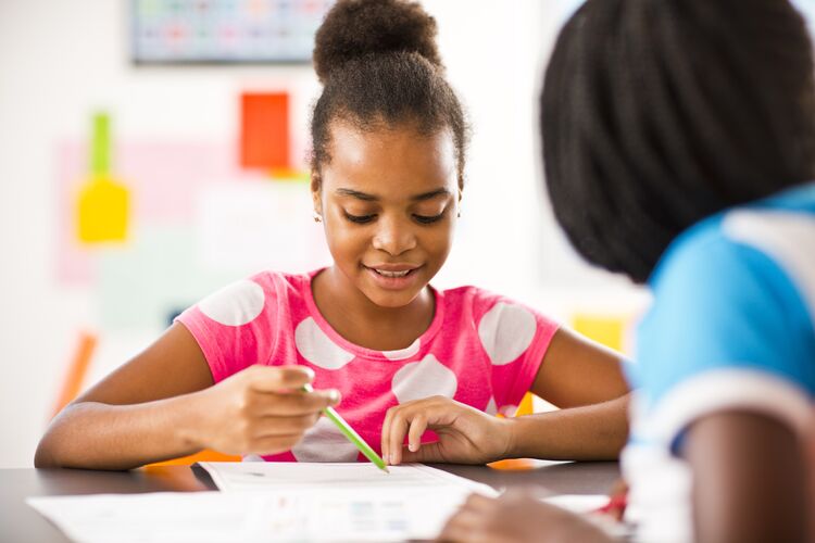 two young learners working together in a class in Mozambique