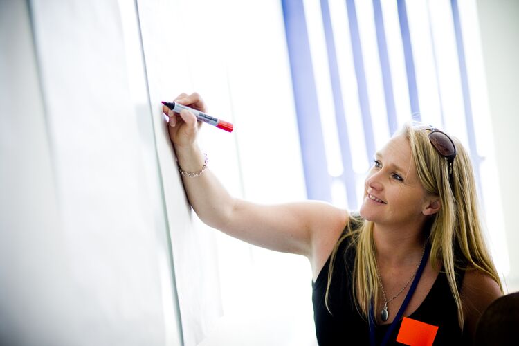 Teacher writing on whiteboard