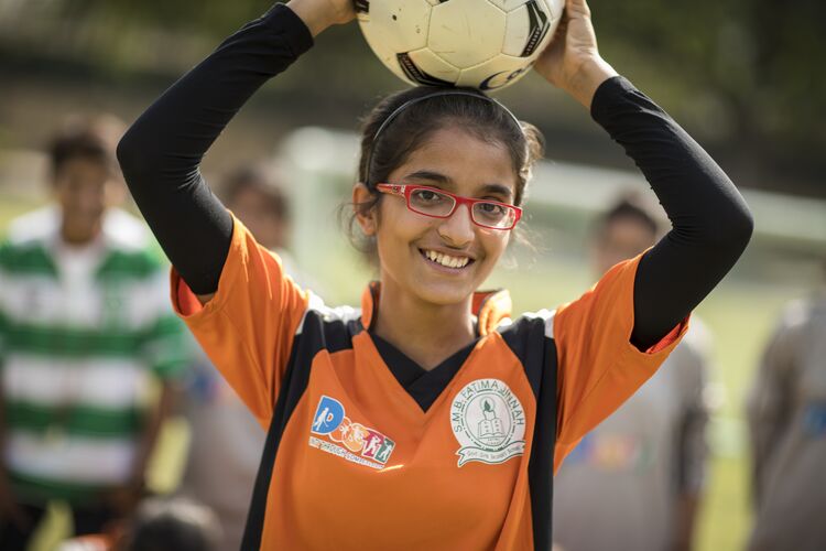 teenage girl with a football