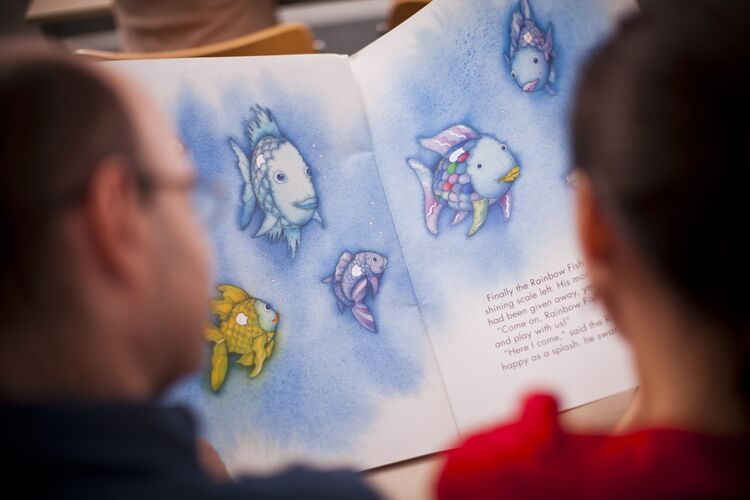 a young learner reading an english book