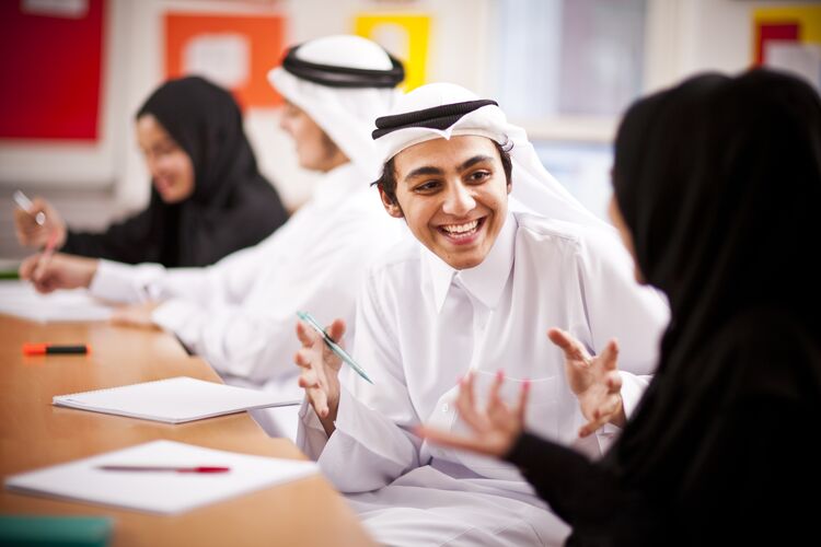 Two students in Qatar classroom practising speaking