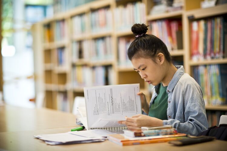 Student in Singapore studying alone in library