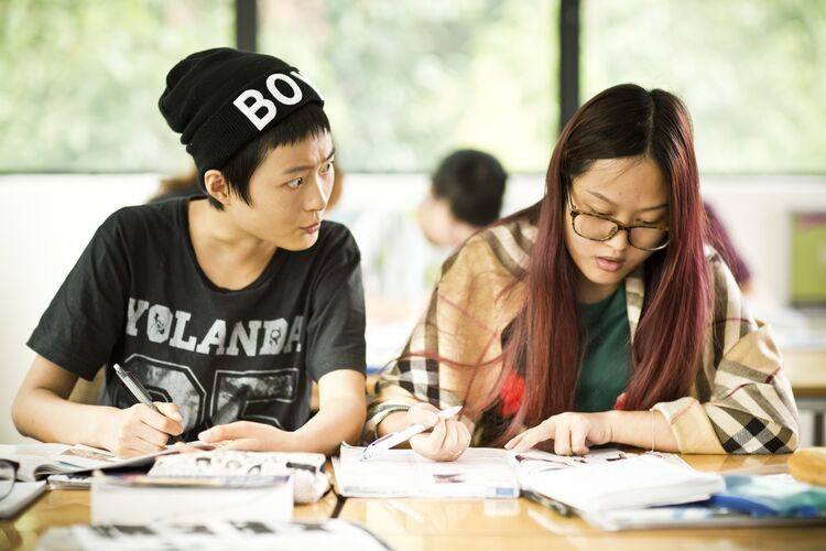 students in Singapore working from a coursebook