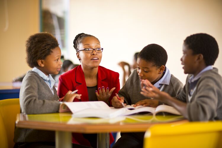 Students talking with their teacher in primary school in South Africa