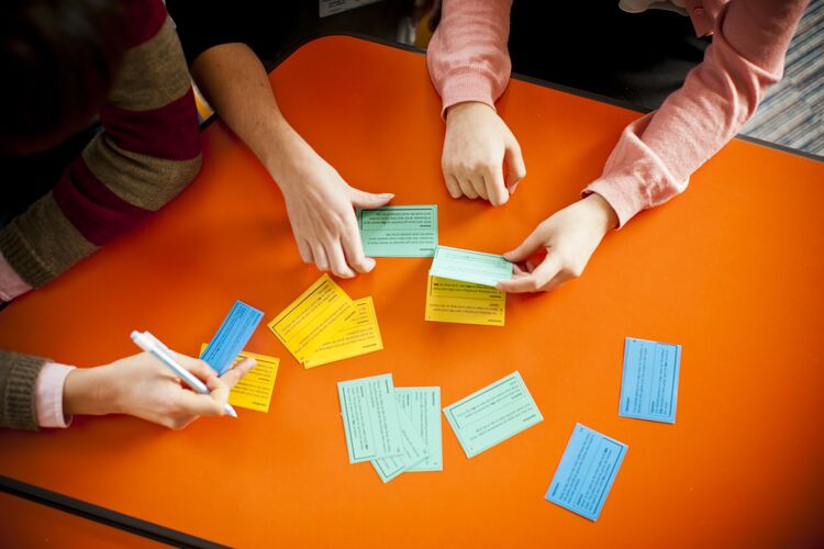 Group of learners organising cards on a desk