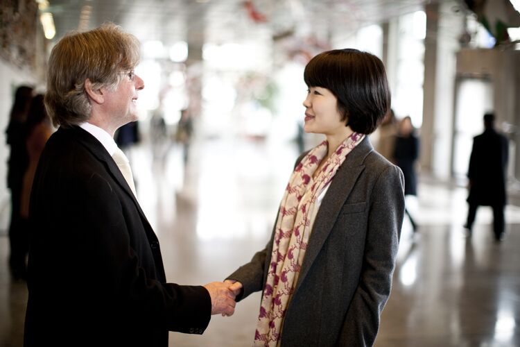 Two people greeting each other with a handshake