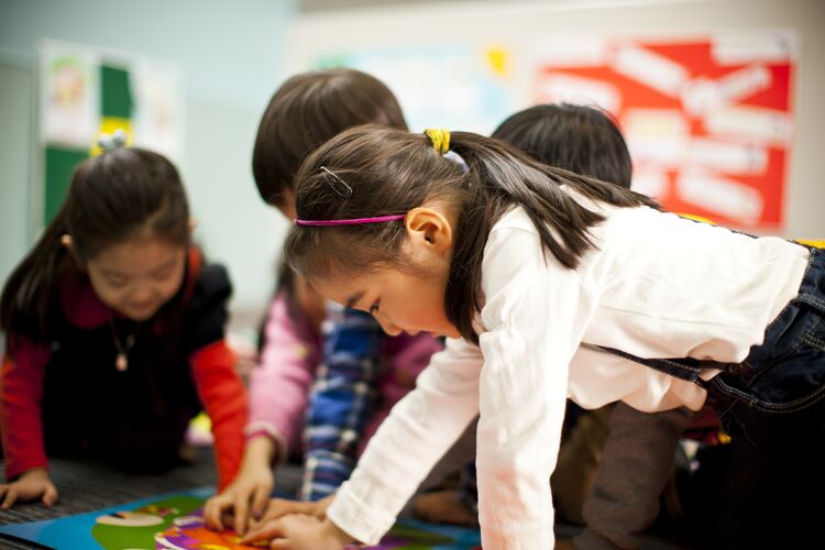 Young learners in South Korea working on a project together