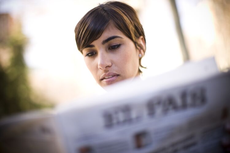 A woman reading a newspaper