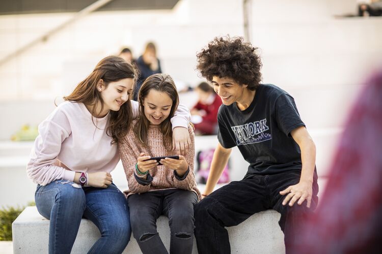 Group of young leaners looking at a tablet