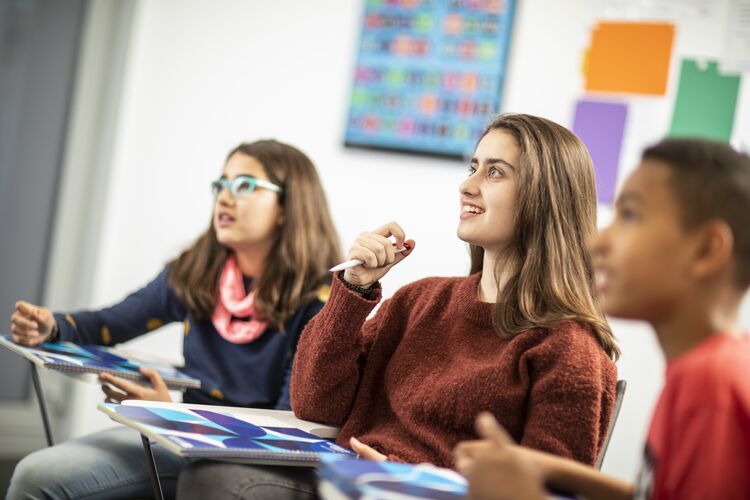 Students looking at teacher in classroom