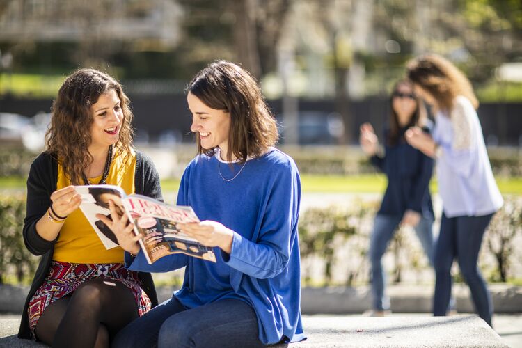 Two women reading a magazine