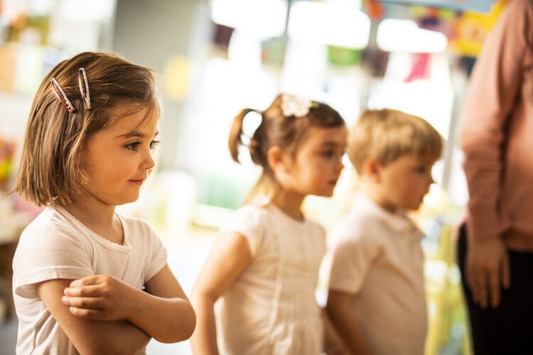 Young learners standing up in class