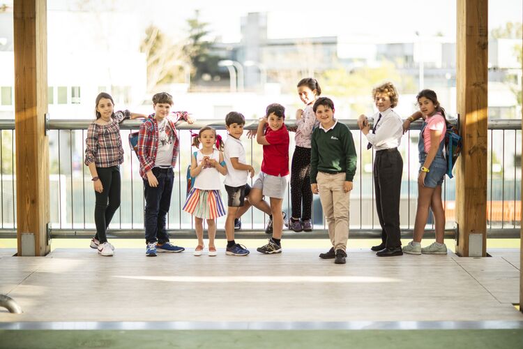 Ten older primary students stand in a line