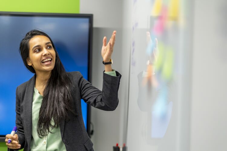 Teacher pointing to a whiteboard