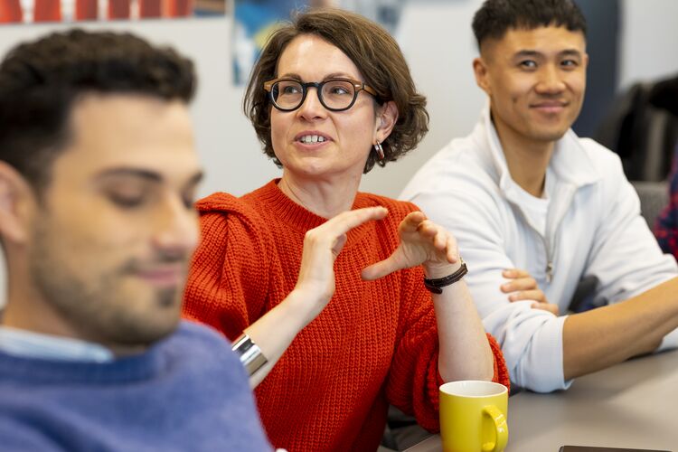 Woman at a desk speaking