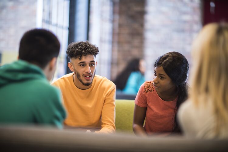 Group of students at a table discussing something