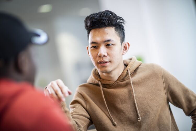 Two male students talking together