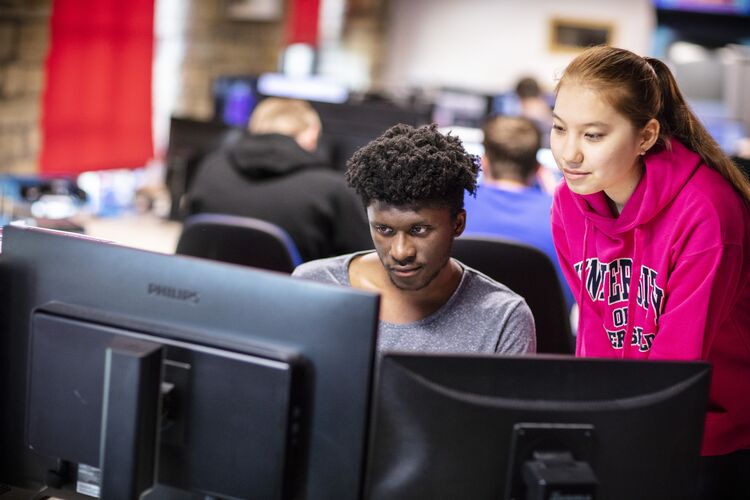 Two students looking at a computer