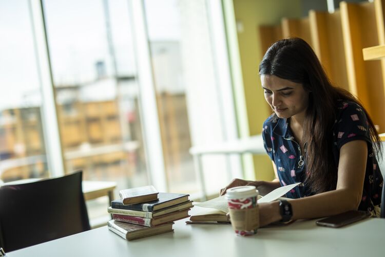 a woman reading at a desk