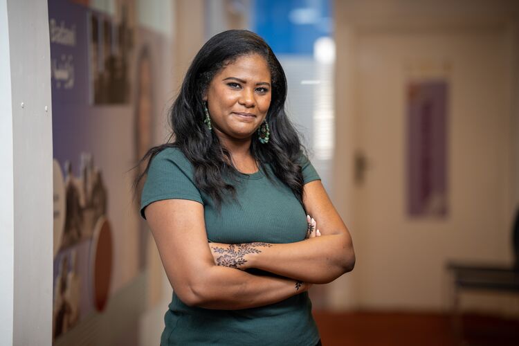 Image of a woman standing with her arms crossed