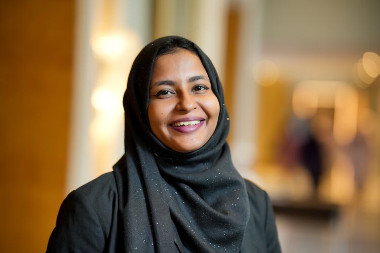 woman in head scarf, smiling