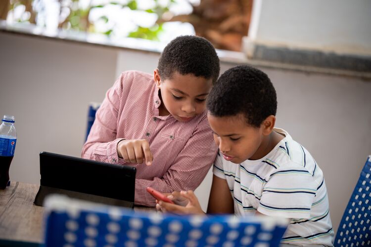 Two boys working with a laptop