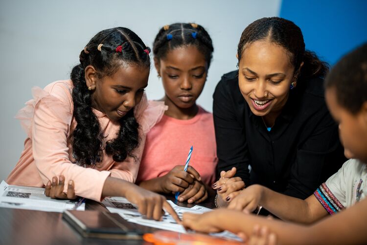 Teacher with young learners in Sudan classroom