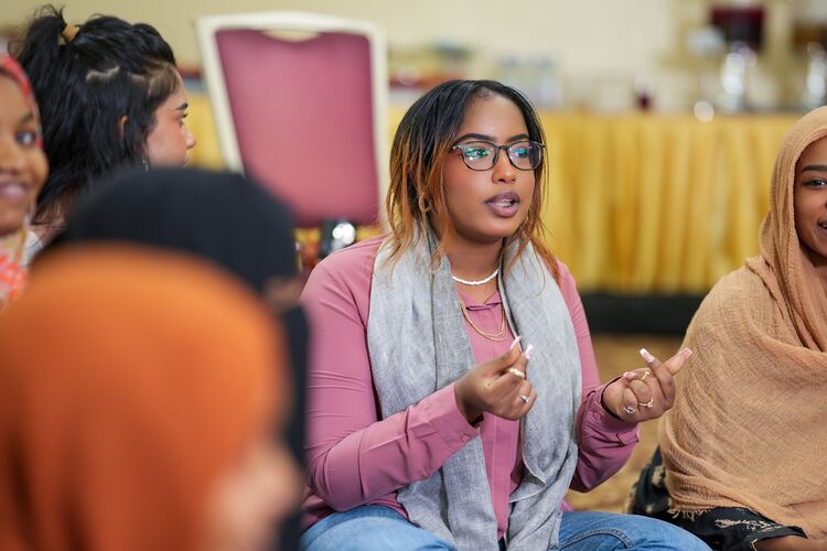 A group of students having a discussion together