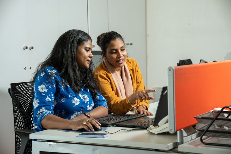 Two Sudanese women teachers working on a webinar together