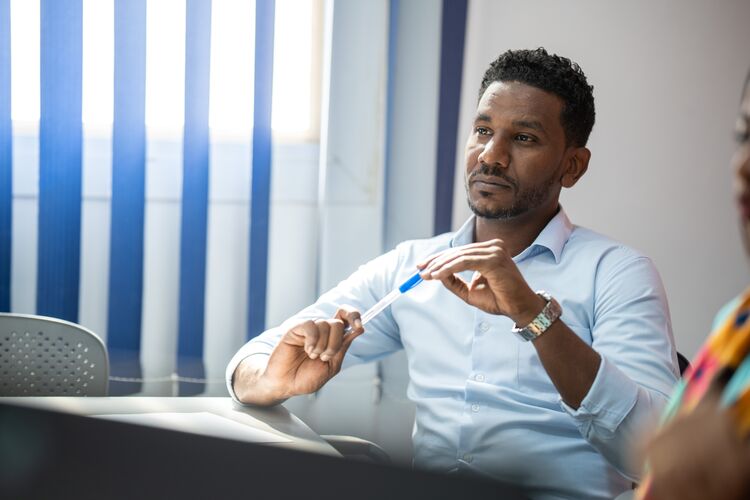 A teacher in Sudan, sitting and thinking