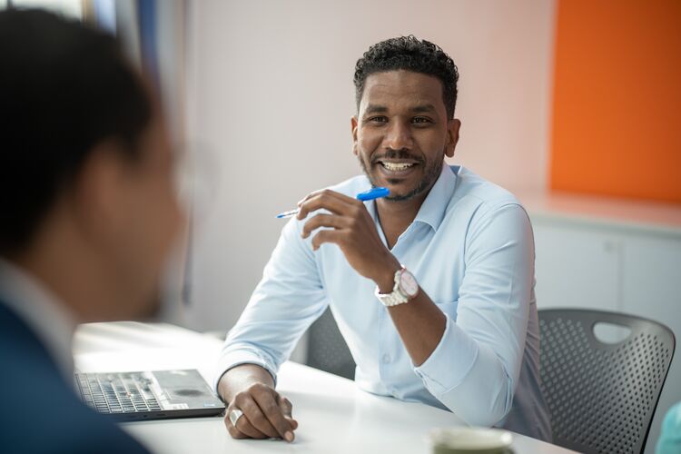 Man in conversation at a desk