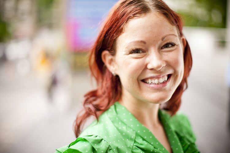 A student smiling outside