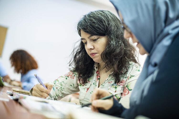 Teacher working with an adult student on a writing task