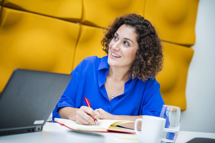 Woman writing notes in a notebook