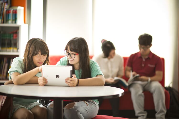 Two teenage girls using a tablet