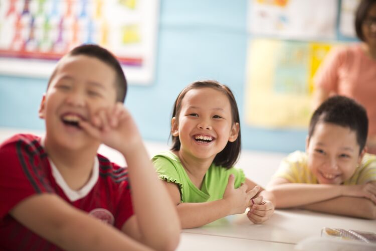 Young learners in a classroom in Vietnam laughing