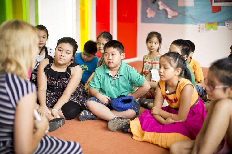 Teacher telling story to young learners in classroom