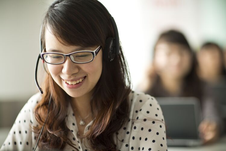 Woman in vietnam talking with a headset