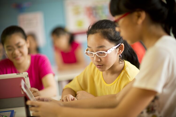 Young learners in Vietnam working together in class