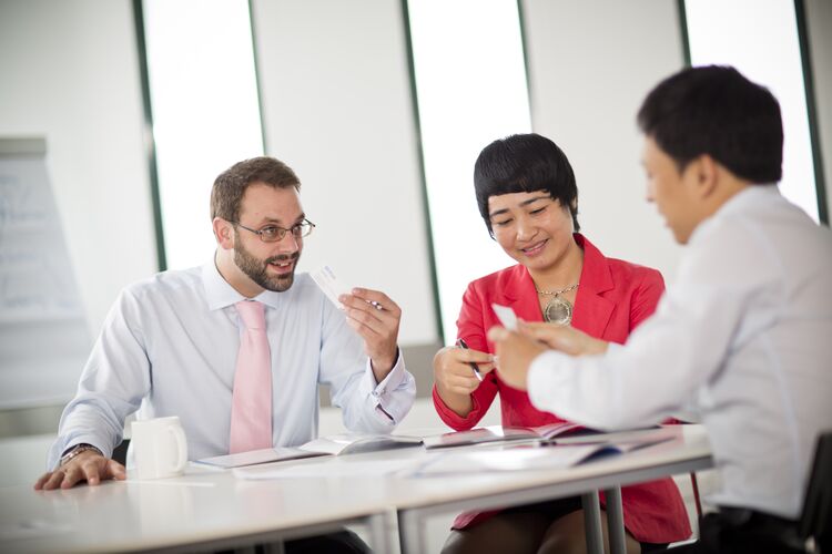 three business English students sitting at a table