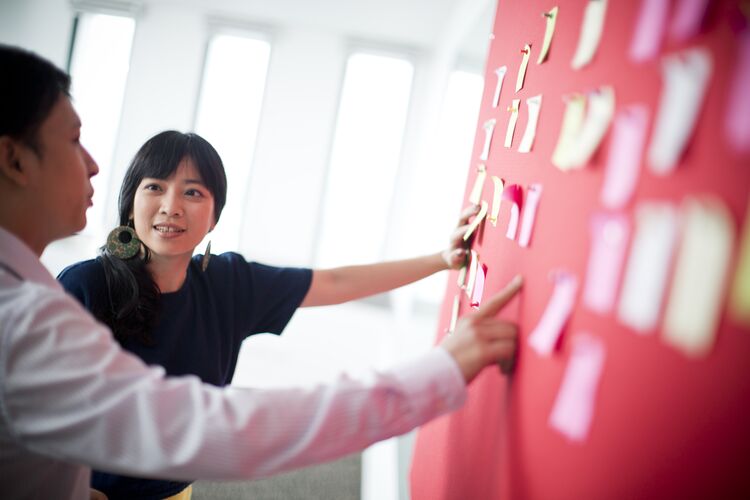 Students in Vietnam looking at a wall with post-it notes on