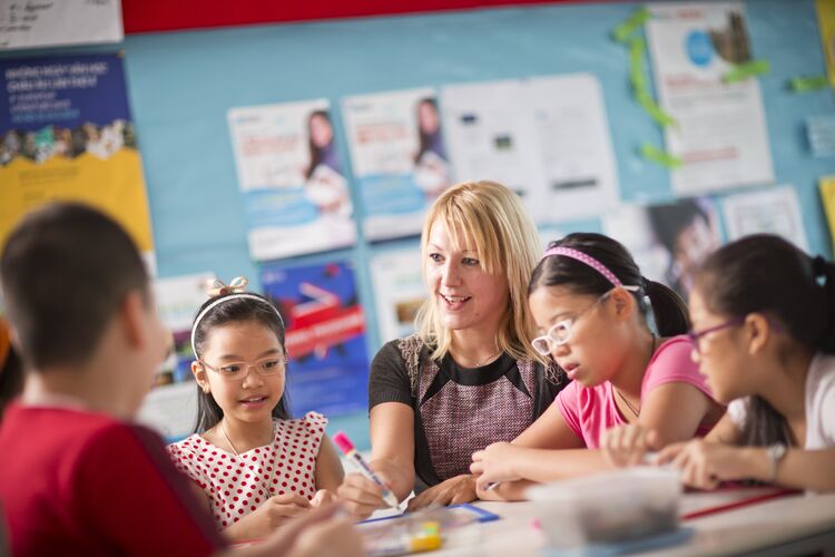 Group of young learners in Vietnam working with their teacher