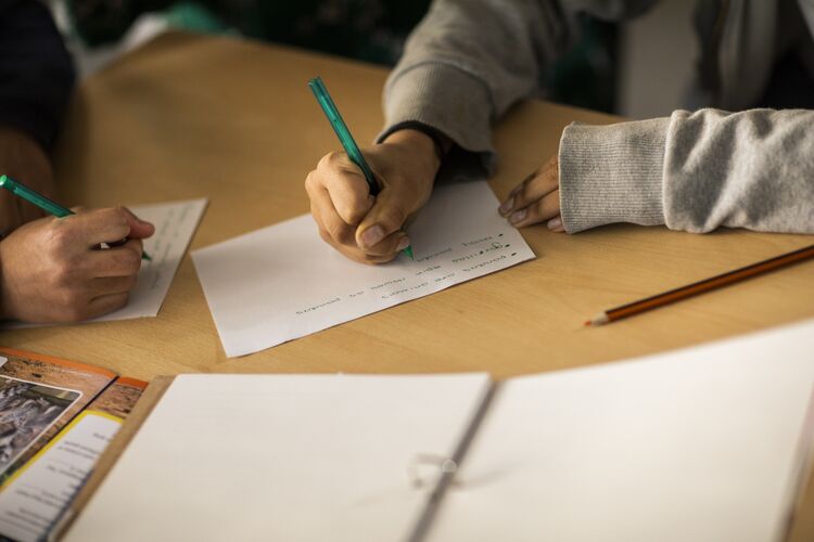 Some students writing in notebooks